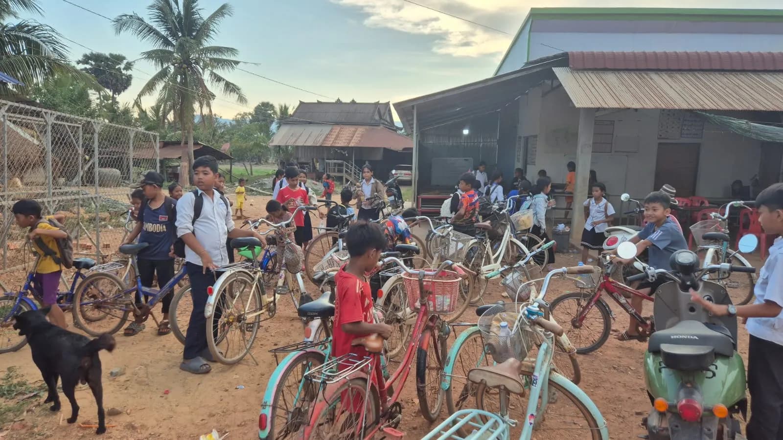 Students gathered with their bicycles outside the school